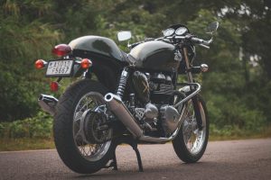 A vintage motorcycle parked outdoors, showcasing a sleek design and chrome details.